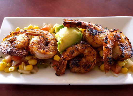 Grilled shrimp on corn salsa with avocado, served at The Grill at Fairview Inn Restaurant Marshfield.