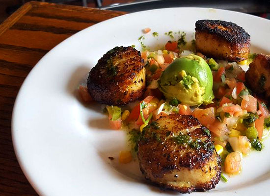 Four seared scallops at The Grill at Fairview Inn Restaurant, Marshfield, Massachusetts.